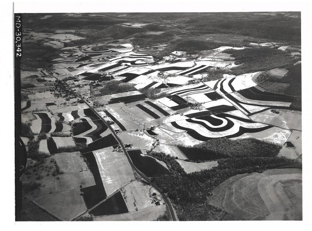 1961 Arial photo of Accident MD shows contour strips on 540 acres, 7300 feet of diversion and 40 acres of tree plantings.