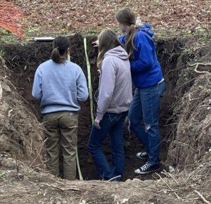 An Envirothon team measures soil