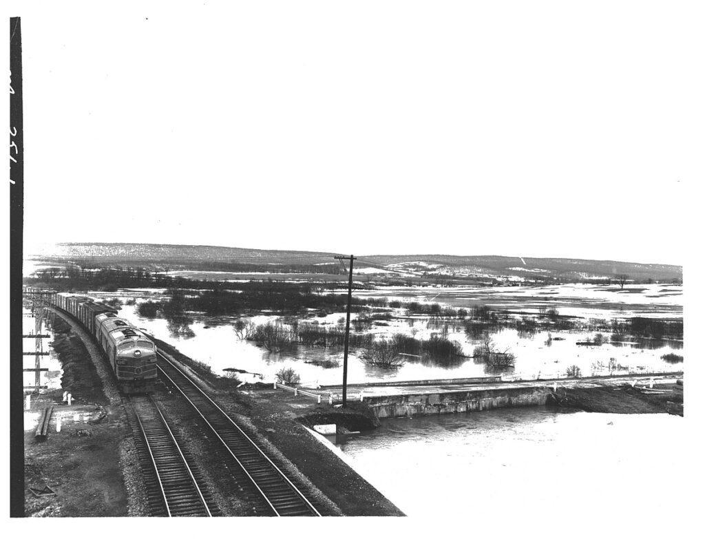 Railroad tracks surrounded by water.