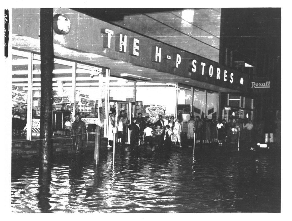 Flooding in downtown Oakland at the HP Store. Many towns people gathered in front of the store to see the flooding.