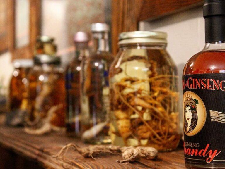 A shelf with jars full of curing Ginseng and a bottle of Ginseng Brandy.