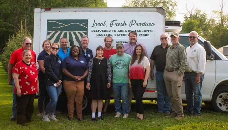 Maryland Department of Agriculture Secretary Kevin Atticks and staff with the Board and Staff of Garrett Growers in front of a Garrett Growers Delivery Truck