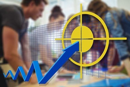 A trend arrow pointing to a bulls eye with a group of people working together over something in the background