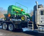 No Till Drill loaded on a flatbed roll off tractor trailer